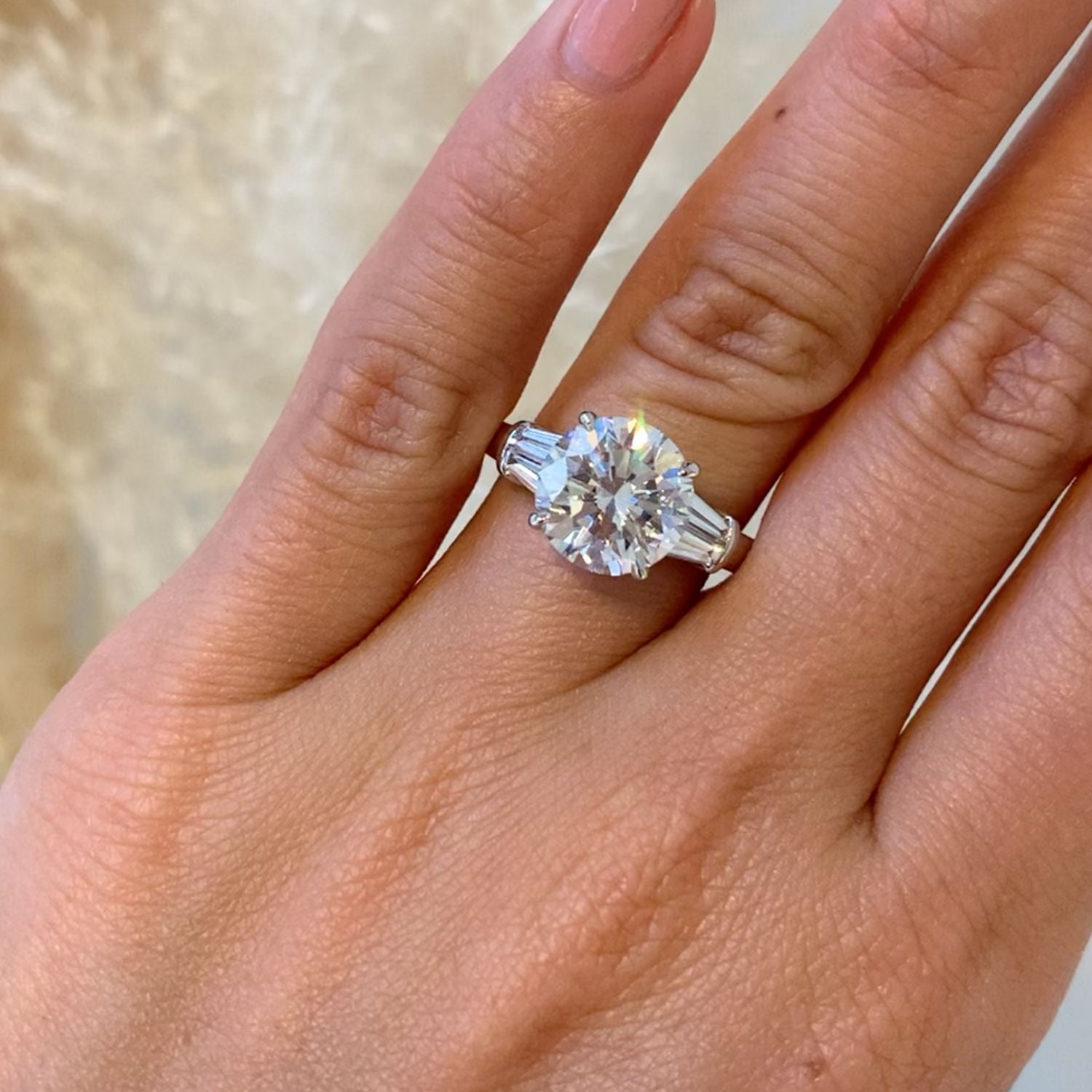 Round diamond with trapezoid side stones Clearance