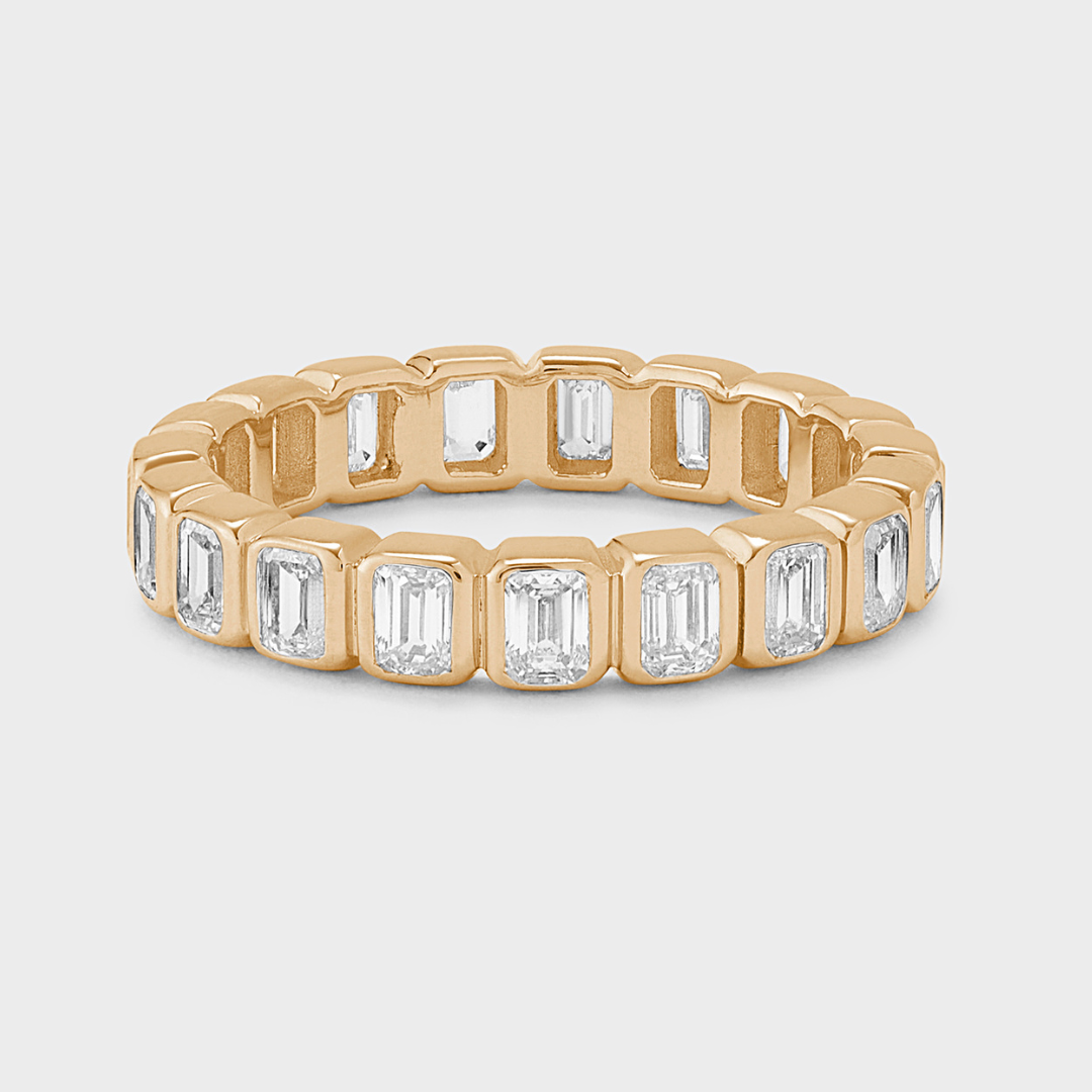 yellow gold eternity band with bezel-set emerald-cut natural diamonds