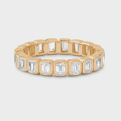 yellow gold eternity band with bezel-set emerald-cut natural diamonds