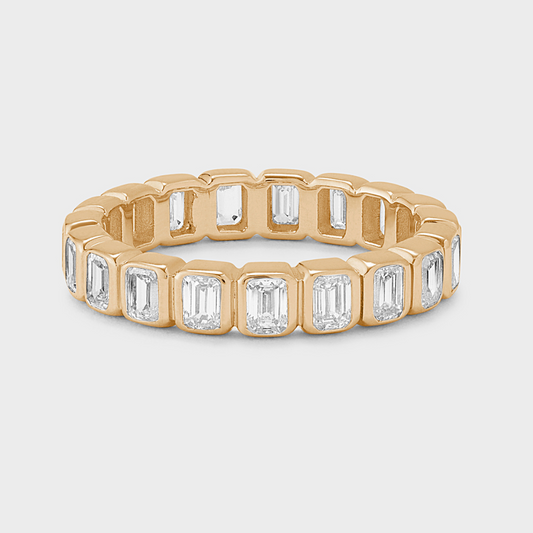 yellow gold eternity band with bezel-set emerald-cut natural diamonds