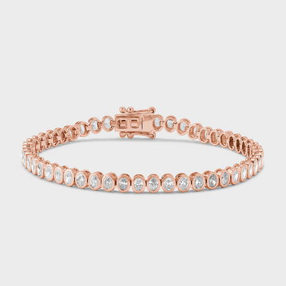 A rose gold tennis bracelet with bezel set, oval shape natural diamonds against a white background. 