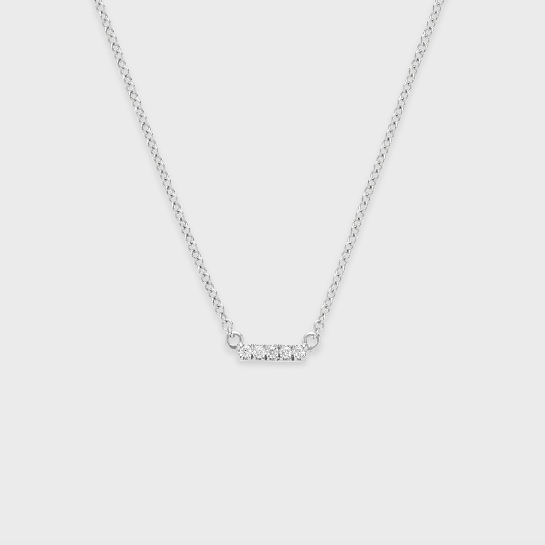 white gold bar pendant necklace with a row of round natural diamonds