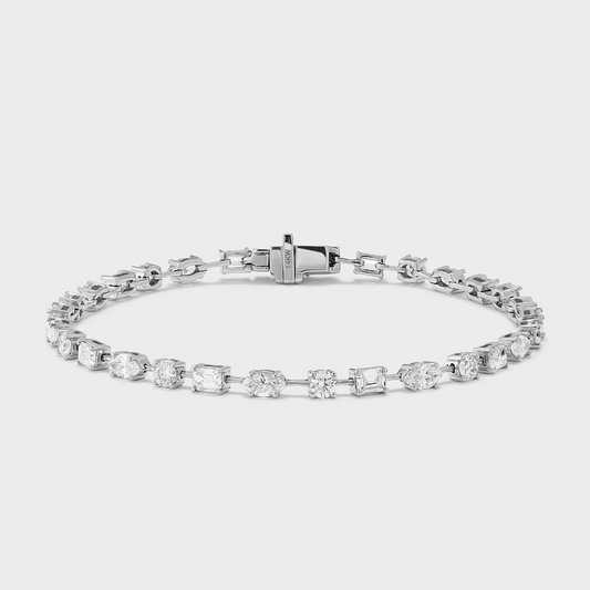 A white gold tennis bracelet with mixed fancy shaped natural diamonds.