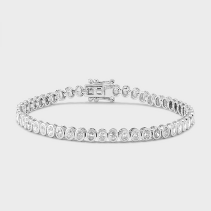 A white gold tennis bracelet with bezel set, oval shape natural diamonds against a white background. 