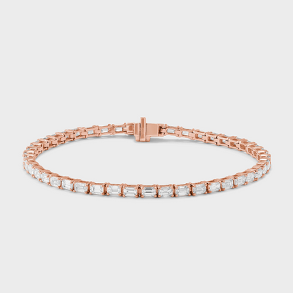 natural diamond tennis bracelet with emerald cut diamonds set east-west in rose gold