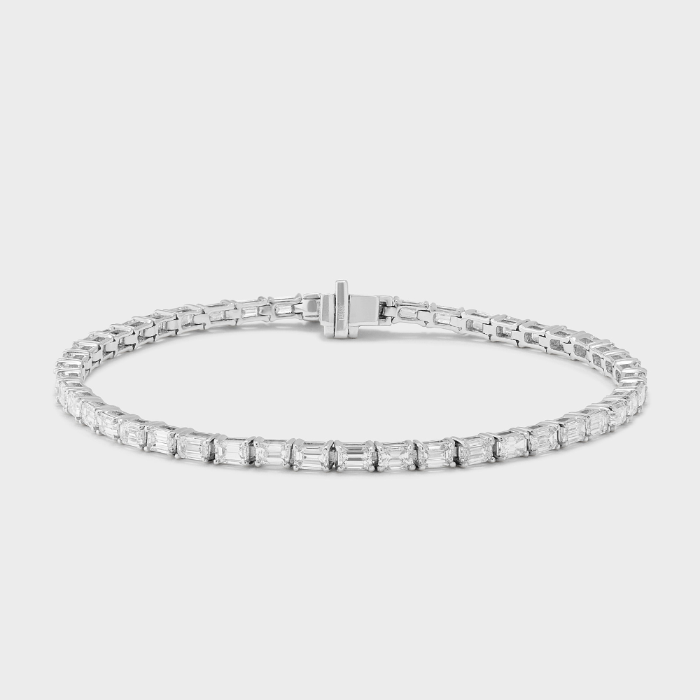 natural diamond tennis bracelet with emerald cut diamonds set east-west in white gold 