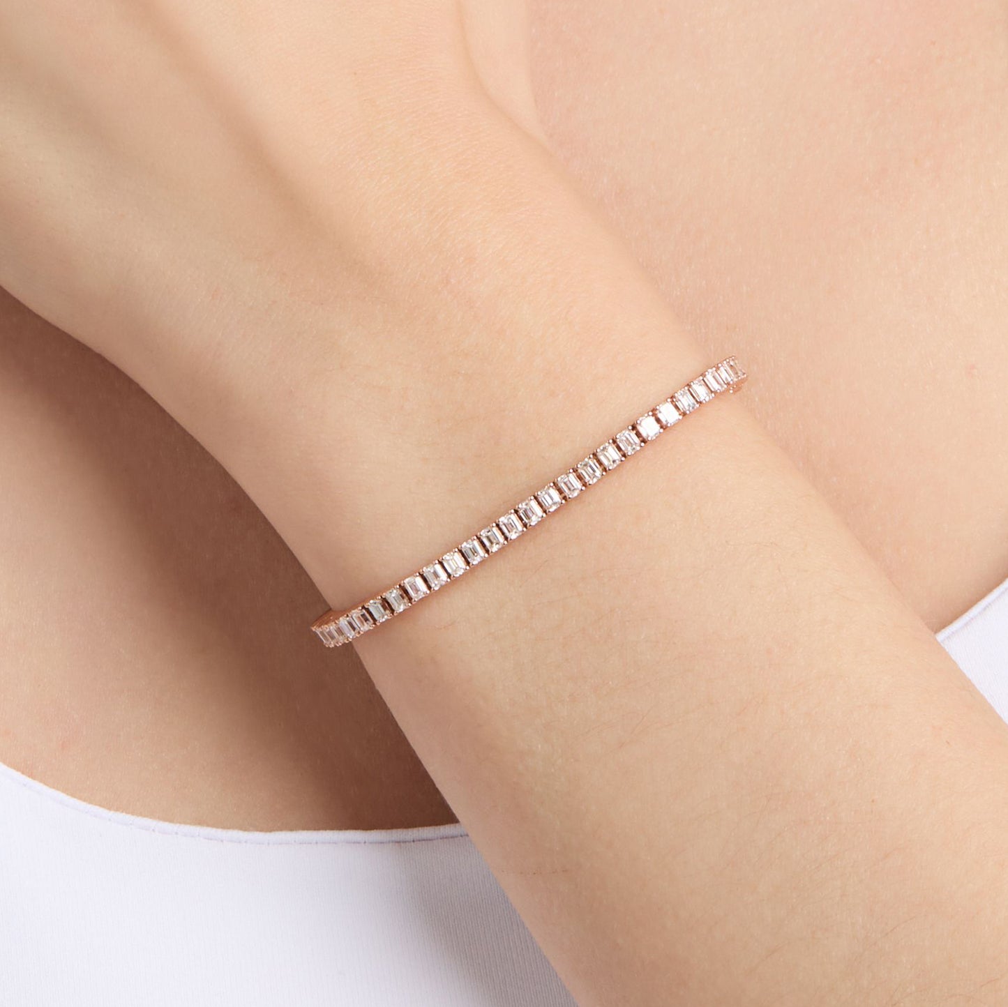 natural diamond tennis bracelet with emerald cut diamonds on wrist