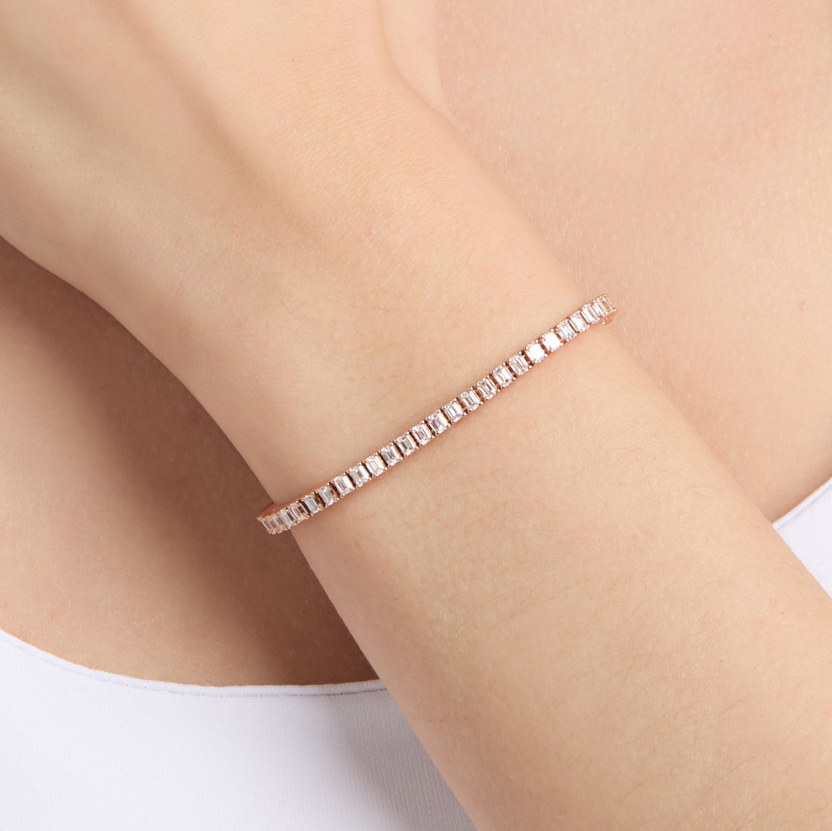 natural diamond tennis bracelet with emerald cut diamonds on wrist