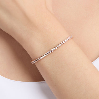 natural diamond tennis bracelet with emerald cut diamonds on wrist