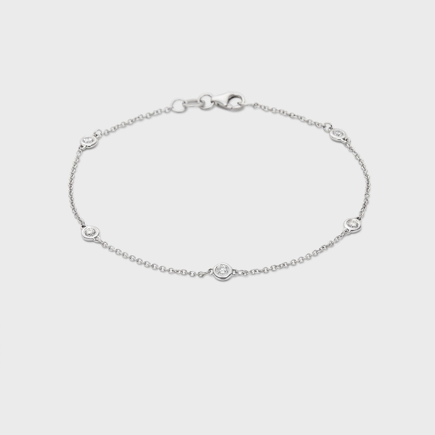 white gold station bracelet with round natural diamonds placed equal distance apart