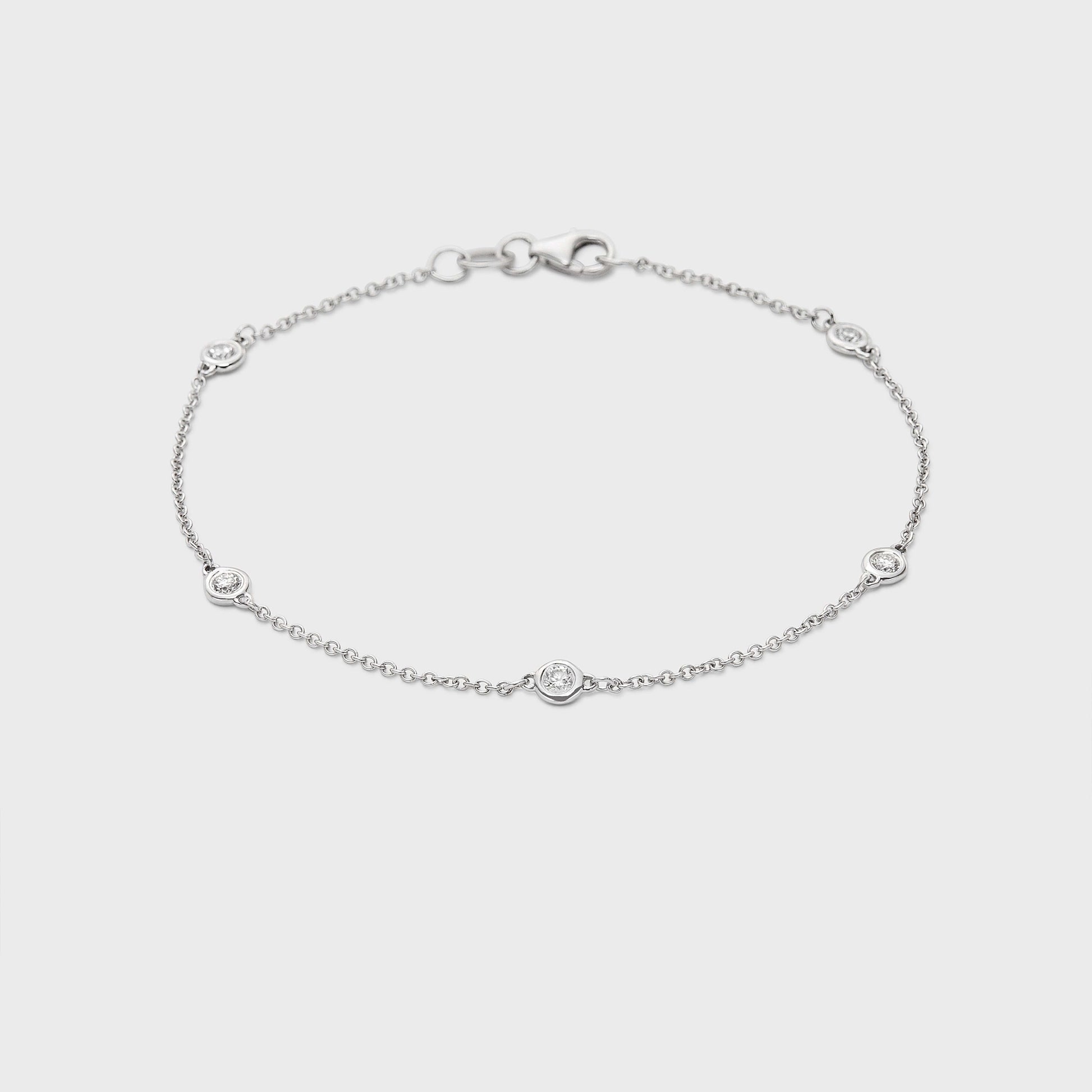 white gold station bracelet with round natural diamonds placed equal distance apart