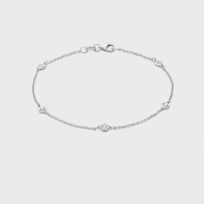 white gold station bracelet with round natural diamonds placed equal distance apart