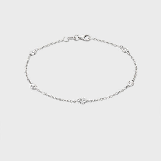 white gold station bracelet with round natural diamonds placed equal distance apart