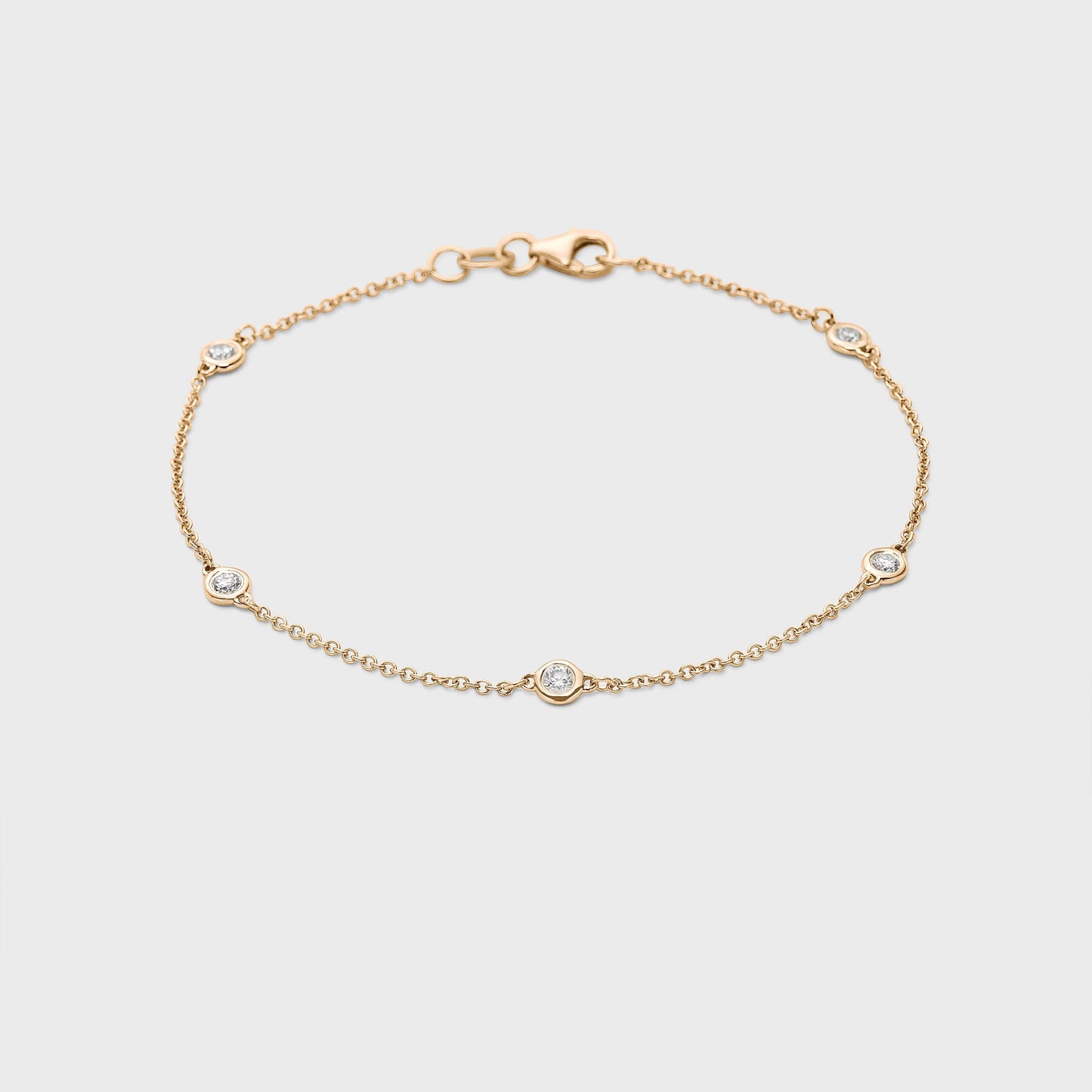 yellow gold station bracelet with round natural diamonds placed equal distance apart
