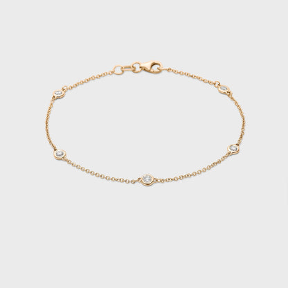 yellow gold station bracelet with round natural diamonds placed equal distance apart