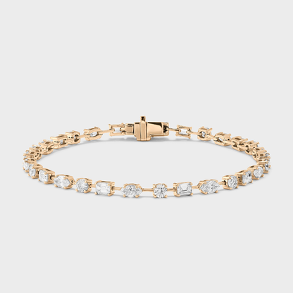 A yellow gold tennis bracelet with mixed fancy shaped natural diamonds.