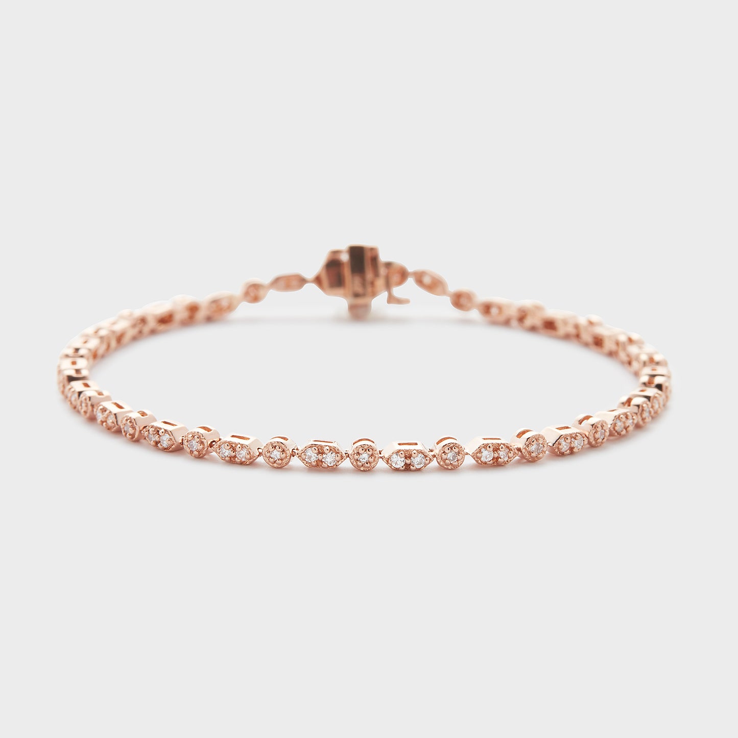 A rose gold bracelet with diamond accents, displayed against a white background.