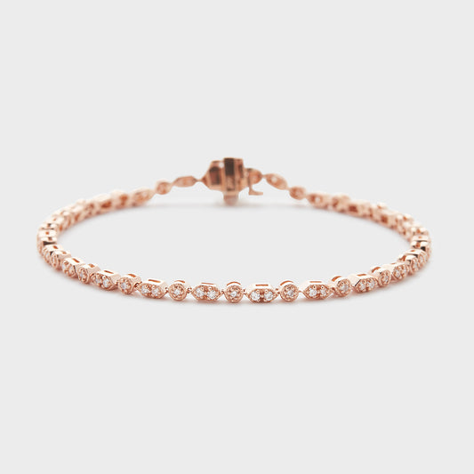 A rose gold bracelet with diamond accents, displayed against a white background.
