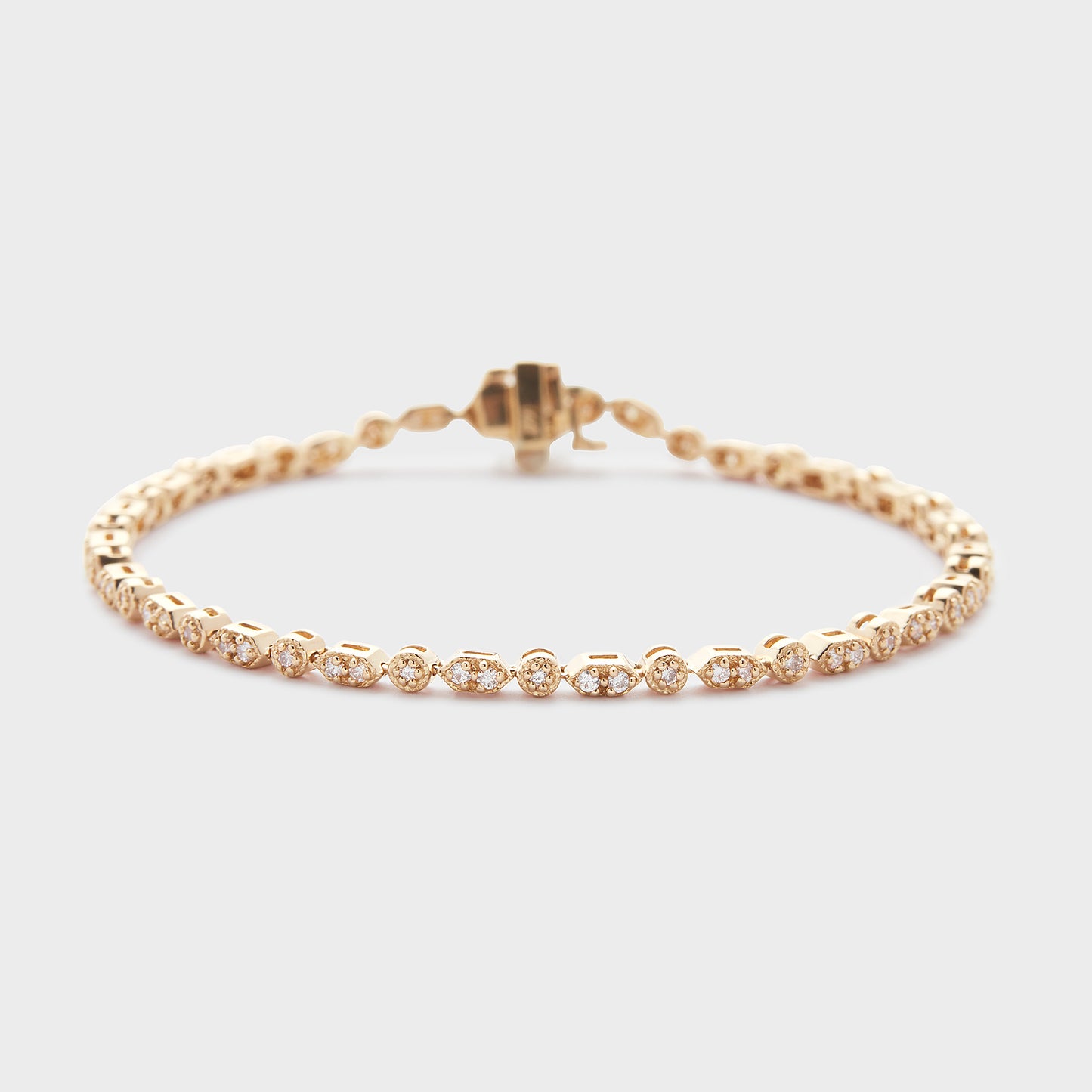 A yellow gold bracelet with diamond accents, displayed against a white background.