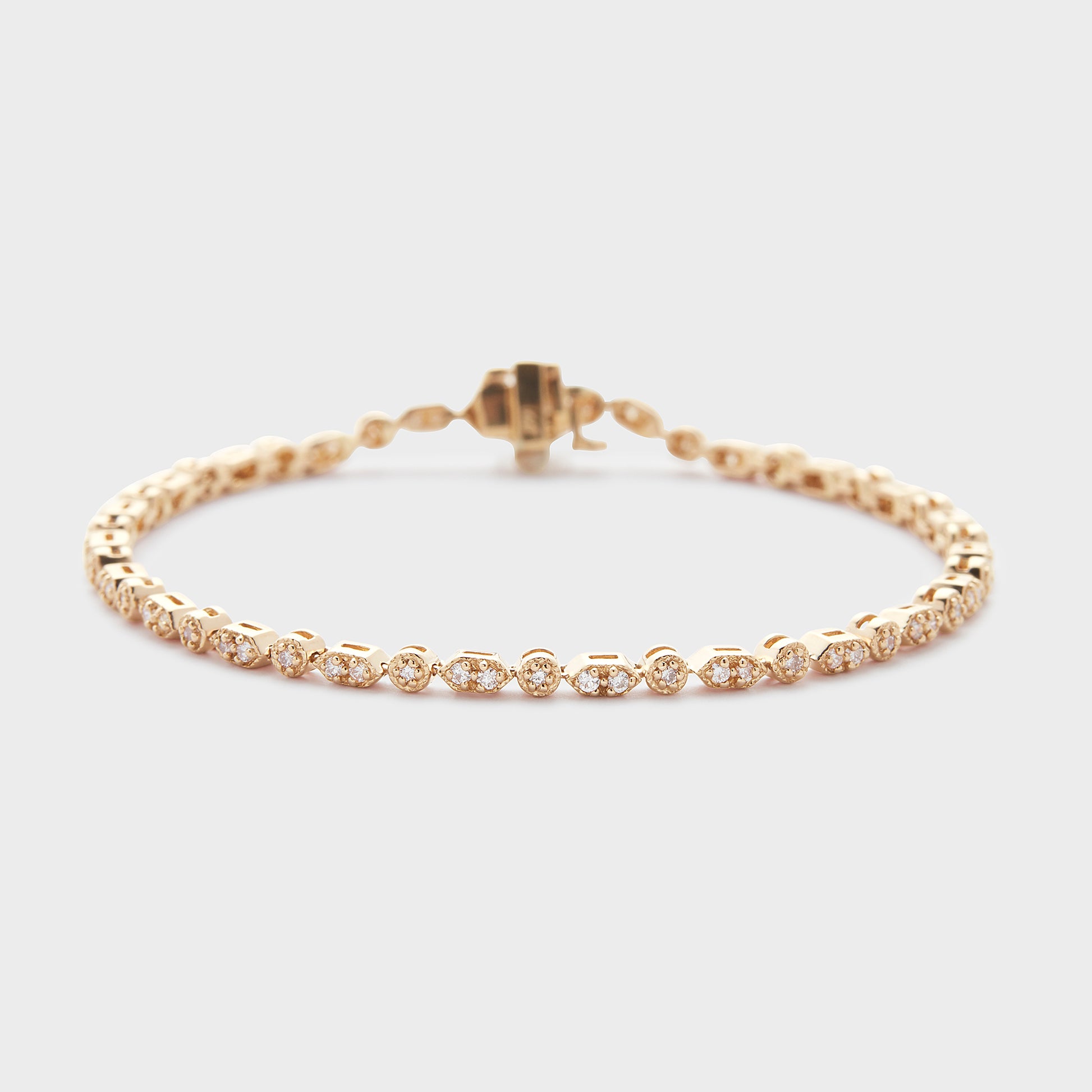 A yellow gold bracelet with diamond accents, displayed against a white background.