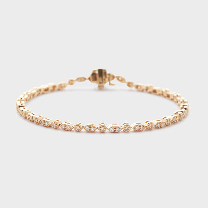 A yellow gold bracelet with diamond accents, displayed against a white background.